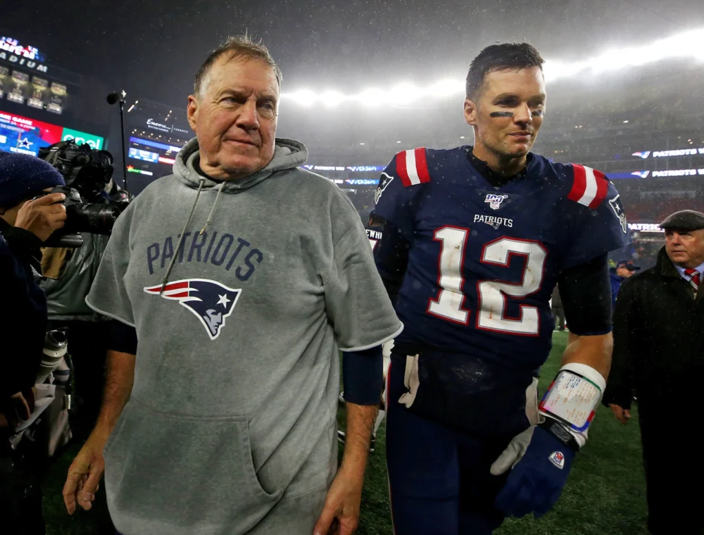 a picture of Tom Brady and coach Bill Belichick leaving a football field